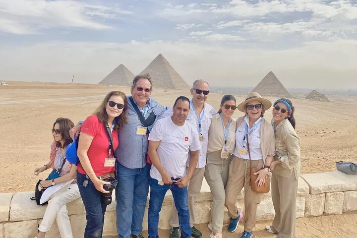 A small group in front of the Giza pyramids on a 10-day luxury Egypt tour, Giza, Egypt
