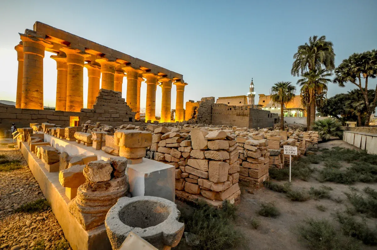 The lit columns of Luxor Temple at dusk on a luxury Egypt tour, Luxor Temple, Luxor, Egypt